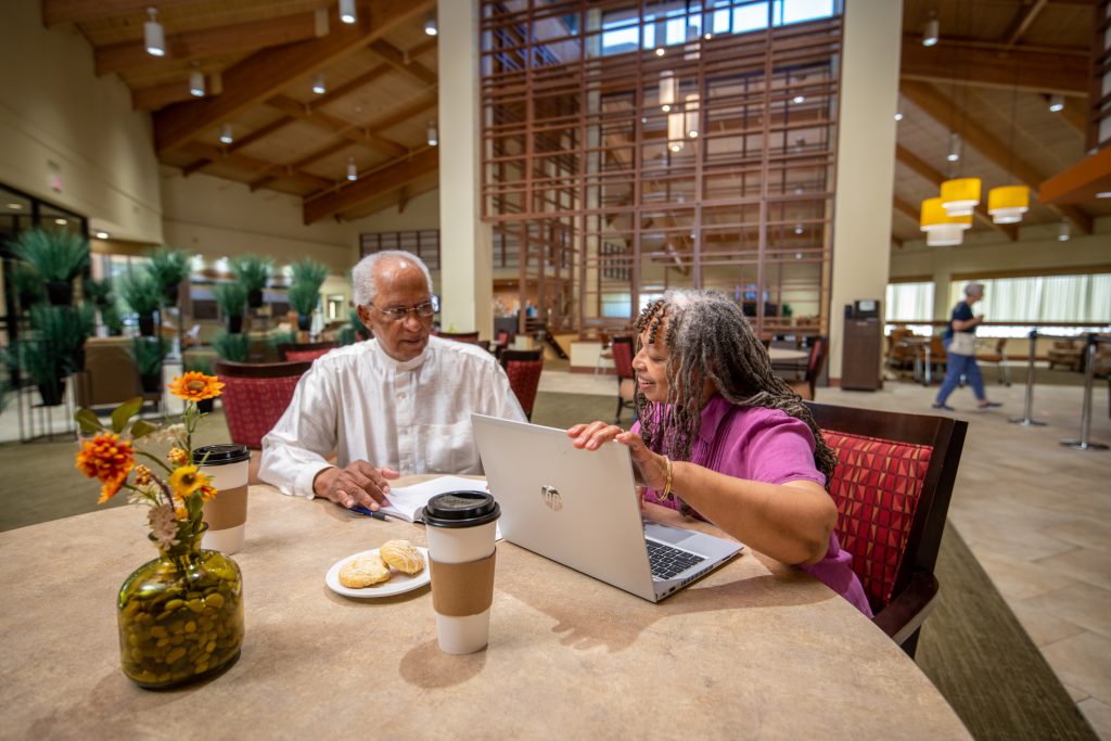 A couple looking on a laptop at retirement communities in Texas